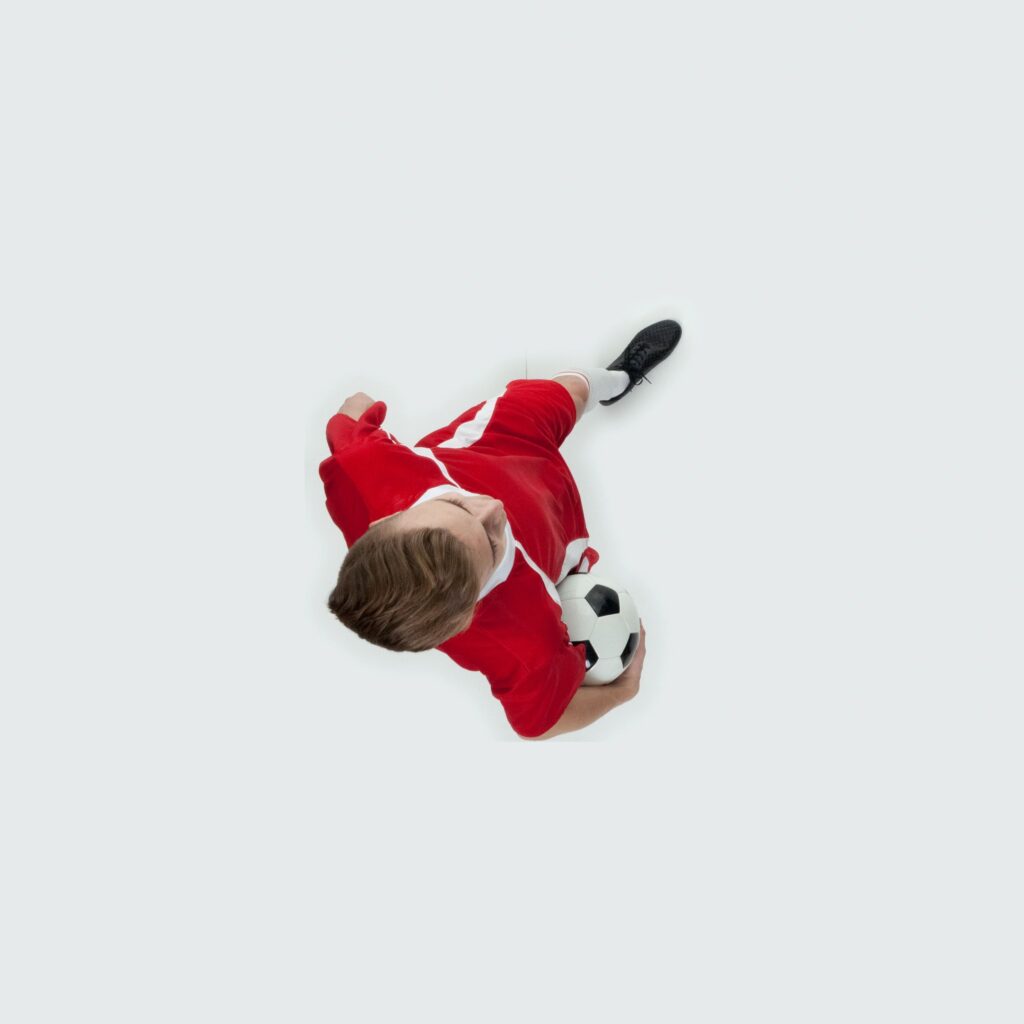 Caucasian teenage boys soccer player walking in front of white background wearing soccer uniform and holding soccer ball and playing soccer - sport and using sports ball