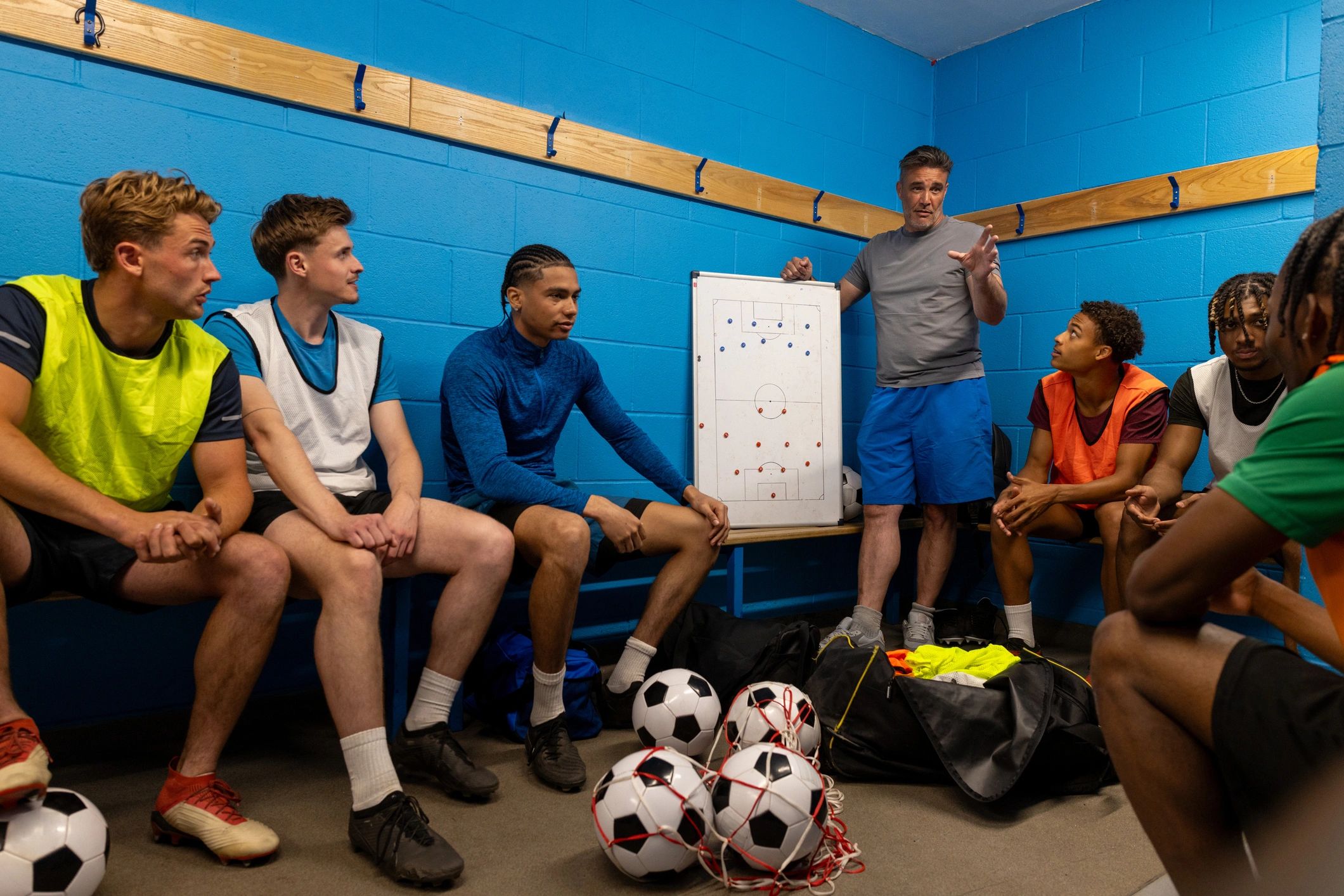 Football team and coach planning together before training